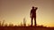 Man travel silhouette. Man shows his hand in the distance standing on mountain silhouette sunlight sunrise