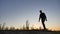 Man travel silhouette. Man shows his hand in the distance standing on mountain silhouette sunrise sunlight