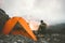 Man traveler alone enjoying sunset in mountains