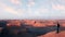 Man traveler on the background of rocky formations in the Dasht e Lut desert against sunset. Nature of Iran. Persia.