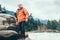 Man Traveler with backpack on the mountain river bank