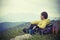 Man Traveler with backpack relaxing with Mountains on Background