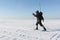 The man the traveler with a backpack skiing on snow