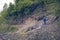 Man traveler with big backpack on a mountain road