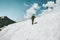 Man Traveler climbing to summit snowy mountains landscape Travel Lifestyle