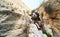 Man traveler climbing up a stepped mountain road. Spain