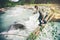 Man Traveler crossing over river on woods outdoor