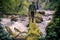 Man Traveler crossing river on log outdoor