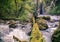 Man Traveler crossing river on log outdoor