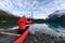 Man traveler holding paddle on red canoe in Spirit Island on Maligne lake at Jasper national park