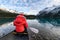 Man traveler holding paddle on red canoe in Spirit Island on Maligne lake at Jasper national park