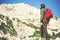 Man Traveler with red backpack climbing Travel Lifestyle