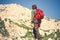 Man Traveler with red backpack climbing Travel Lifestyle concept