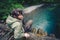 Man Traveler relaxing on wooden bridge over river