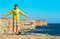 Man Traveler standing outdoor hands raised to the blue sky