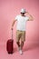 Man traveler with suitcase, passport and ticket on color background.