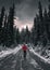 Man traveler walking on dirty road in the forest with snow covered at Yoho national park