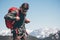 Man Traveler wearing backpack hiking in mountains