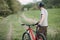 Man traveling in the countryside riding a bicycle