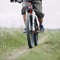 Man traveling riding bicycle along a country road.