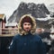 Man traveller sitting on a pier in Reine village, Norway