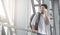 Man traveller talking on cellphone in airport, waiting boarding for flight