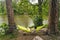 Man travels on bicycle, relaxing in green hammock, surfing Internet on smartphone, listening music on headphones in