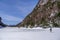 Man trecking across a frozen lake