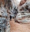 Man trekking through blue rock cavern around White Rock in Valley of Fire State Park