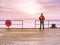 Man in trekking suit in harbor in daybreak