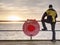 Man in trekking suit in harbor in daybreak