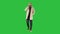 Man in trench coat walking and talking on the phone on a green screen, chroma key.
