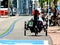 Man on tricycle on divided asphalt bicycle and pedestrian path