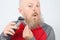 Man trimmer corrects his beard
