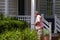 A man trimming off the shrub on his front yard