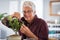 Man trimming plant at home