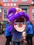 Man Trying on a Purple Chinese Lion Costume