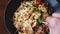 Man trying to get more food on fork POV slow motion shot. Italian pasta with fryed chicked, sour cream and rukkola salad