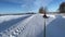 man on a tubing rushes along a country road in winter