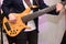 man tuning bass guitar closeup