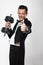 Man in tuxedo holds dumbell.