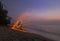 Man twirling fireworks on beach