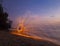 Man twirling fireworks on beach