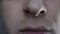 The man twitches his nostrils nervously. Emotions of anger and rage. Human nose close-up. Human breath