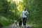 A man with two dogs walking on a sunny meadow