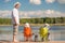 Man and two sons on fishing, father teaches children
