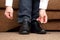 Man tying shoelaces on classic black shoes