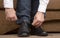 Man tying shoelaces on classic black shoes