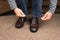 Man tying shoelaces on classic brown Oxford shoes