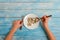 A man types wooden spoon in a spoon, on a blue wooden background